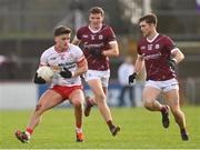 18 February 2024; Michael McKernan of Tyrone in action against John Daly, centre, and Cathal Sweeney of Galway during the Allianz Football League Division 1 match between Tyrone and Galway at O'Neills Healy Park in Omagh, Tyrone. Photo by Ramsey Cardy/Sportsfile
