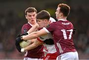18 February 2024; Niall Devlin of Tyrone is tackled by John Daly, left, and Daniel O'Flaherty of Galway during the Allianz Football League Division 1 match between Tyrone and Galway at O'Neills Healy Park in Omagh, Tyrone. Photo by Ramsey Cardy/Sportsfile