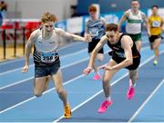 18 February 2024; Nick Griggs of CNDR AC, Antrim, left, and Cathal Doyle of Clonliffe Harriers AC, Dublin, fall at the finsh line in the senior men's 1500m during day two of the 123.ie National Senior Indoor Championships at the Sport Ireland National Indoor Arena in Dublin. Photo by Tyler Miller/Sportsfile