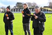 18 February 2024; TG4 floor manager Odhrán Mac Murchadha makes notes as analysts Marcus Ó Buachalla, left, and Charlie Vernon prepare to go on air before the Allianz Football League Division 2 match between Kildare and Armagh at Netwatch Cullen Park in Carlow. Photo by Piaras Ó Mídheach/Sportsfile