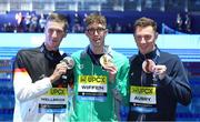 18 February 2024; Daniel Wiffen of Ireland, centre, who won gold, with silver medallist Florian Wellbrock of Germany, left, and bronze medallist David Aubry of France after the Men's 1500m freestyle final during day eight of the World Aquatics Championships 2024 at the Aspire Dome in Doha, Qatar. Photo by Ian MacNicol/Sportsfile
