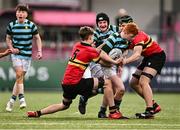 9 February 2024; Adam Moore of St Gerard's School in action against Joshua Rigby, left, and James Lambert during Bank of Ireland Leinster Schools Junior Cup Round 1 match between CBC Monkstown and St Gerard's School at Energia Park in Dublin. Photo by Piaras Ó Mídheach/Sportsfile