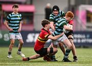 9 February 2024; Adam Moore of St Gerard's School in action against Joshua Rigby, left, and James Lambert during Bank of Ireland Leinster Schools Junior Cup Round 1 match between CBC Monkstown and St Gerard's School at Energia Park in Dublin. Photo by Piaras Ó Mídheach/Sportsfile