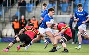 23 February 2024; Zack Hopkins of St Mary’s College is tackled by Milo Quinn, left, and Charlie Meagher of CBC Monkstown during the Bank of Ireland Leinster Schools Senior Cup quarter-final match between CBC Monkstown and St Mary's Collegee at Energia Park in Dublin. Photo by Daire Brennan/Sportsfile