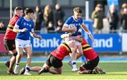 23 February 2024; Zack Hopkins of St Mary’s College is tackled by Christopher O’Toole, left, and Ben Tomkins of CBC Monkstown during the Bank of Ireland Leinster Schools Senior Cup quarter-final match between CBC Monkstown and St Mary's Collegee at Energia Park in Dublin. Photo by Daire Brennan/Sportsfile