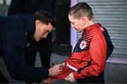 23 February 2024; St Patrick's Athletic supporter Frankie Dunne-Courtney has his jersey signed by Anto Breslin of St Patrick's Athletic before the SSE Airtricity Men's Premier Division match between St Patrick's Athletic and Bohemians at Richmond Park in Dublin. Photo by Harry Murphy/Sportsfile