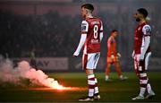 23 February 2024; Chris Forrester and Jake Mulraney of St Patrick's Athletic look on as flares are thrown onto the pitch during the SSE Airtricity Men's Premier Division match between St Patrick's Athletic and Bohemians at Richmond Park in Dublin. Photo by Harry Murphy/Sportsfile
