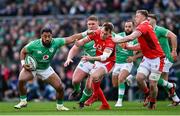24 February 2024; Bundee Aki of Ireland in action against Nick Tompkins of Wales during the Guinness Six Nations Rugby Championship match between Ireland and Wales at Aviva Stadium in Dublin. Photo by Ramsey Cardy/Sportsfile