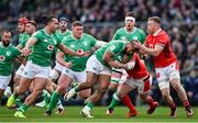 24 February 2024; Bundee Aki of Ireland is tackled by Nick Tompkins and Tommy Reffell of Wales during the Guinness Six Nations Rugby Championship match between Ireland and Wales at Aviva Stadium in Dublin. Photo by Ramsey Cardy/Sportsfile