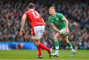 24 February 2024; Ciarán Frawley of Ireland in action against George North of Wales during the Guinness Six Nations Rugby Championship match between Ireland and Wales at Aviva Stadium in Dublin. Photo by Ramsey Cardy/Sportsfile