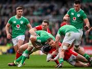24 February 2024; Caelan Doris of Ireland is tackled by George North and Cameron Winnett of Wales during the Guinness Six Nations Rugby Championship match between Ireland and Wales at Aviva Stadium in Dublin. Photo by Ramsey Cardy/Sportsfile