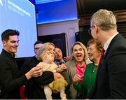 24 February 2024; Jarlath Burns, right, with his family, from left, his son Jarly Óg, his son Fionnan, his daughter Megan O'Keeffe holding his granddaughter Blaithín, his wife Suzanne and his mother Helen after he took over as Uachtarán Chumann Lúthchleas Gael at the GAA Congress at Canal Court Hotel in Newry, Down. Photo by Piaras Ó Mídheach/Sportsfile