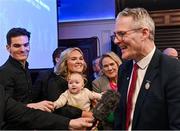 24 February 2024; Jarlath Burns, right, is interviewed as his family, from left, his son Jarly Óg, his daughter Megan O'Keeffe holding his granddaughter Blaithín, and his wife Suzanne looks on after he took over as Uachtarán Chumann Lúthchleas Gael at the GAA Congress at Canal Court Hotel in Newry, Down. Photo by Piaras Ó Mídheach/Sportsfile