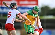 24 February 2024; Stephen Gillespie of Donegal is tackled by Bryan McGurk, left, and Cormac Munroe of Tyrone during the Allianz Hurling League Division 2 Group B match between Tyrone and Donegal at O'Neills Healy Park in Omagh, Tyrone. Photo by Ben McShane/Sportsfile
