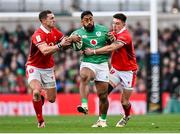 24 February 2024; Bundee Aki of Ireland is tackled by George North and Josh Adams of Wales during the Guinness Six Nations Rugby Championship match between Ireland and Wales at Aviva Stadium in Dublin. Photo by Ramsey Cardy/Sportsfile