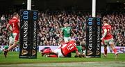 24 February 2024; Bundee Aki of Ireland scores his side's third try, which was subsequently disallowed, despite the tackle of George North and Nick Tompkins of Wales during the Guinness Six Nations Rugby Championship match between Ireland and Wales at Aviva Stadium in Dublin. Photo by Sam Barnes/Sportsfile