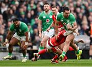 24 February 2024; James Lowe of Ireland is tackled by Cameron Winnett of Wales during the Guinness Six Nations Rugby Championship match between Ireland and Wales at Aviva Stadium in Dublin. Photo by Ramsey Cardy/Sportsfile