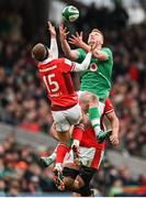 24 February 2024; Ciarán Frawley of Ireland and Cameron Winnett of Wales contest a high ball during the Guinness Six Nations Rugby Championship match between Ireland and Wales at Aviva Stadium in Dublin. Photo by Ramsey Cardy/Sportsfile