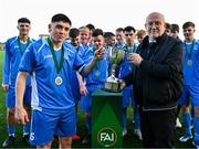 24 February 2024; Sam Conway of Dublin & District Schoolboys League is presented with the cup by FAI Director of Competitions Fran Gavin after the FAI Youth Inter League Cup final match between Dublin & District Schoolboys League and Galway Football Association at Athlone Town Stadium in Westmeath. Photo by Tyler Miller/Sportsfile