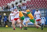 24 February 2024; Joe McToal of Tyrone in action against Conor Gartland, centre, and Ciaran Curran of Donegal during the Allianz Hurling League Division 2 Group B match between Tyrone and Donegal at O'Neills Healy Park in Omagh, Tyrone. Photo by Ben McShane/Sportsfile