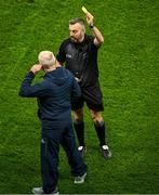 24 February 2024; Referee Kevin Jordan issues a yellow card to Dublin manager Micheál Donoghue, before starting the second half, during the Allianz Hurling League Division 1 Group B match between Dublin and Limerick at Croke Park in Dublin. Photo by Ray McManus/Sportsfile