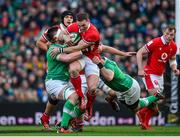 24 February 2024; George North of Wales is tackled by Ireland players Joe McCarthy, left, and Peter O’Mahony during the Guinness Six Nations Rugby Championship match between Ireland and Wales at the Aviva Stadium in Dublin. Photo by Seb Daly/Sportsfile