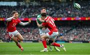 24 February 2024; Calvin Nash of Ireland offloads as he is tackled by Josh Adams of Wales during the Guinness Six Nations Rugby Championship match between Ireland and Wales at the Aviva Stadium in Dublin. Photo by Seb Daly/Sportsfile