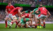 24 February 2024; Jamison Gibson-Park of Ireland is tackled by Wales players Gareth Thomas, left, and Sam Costelow, behind, during the Guinness Six Nations Rugby Championship match between Ireland and Wales at the Aviva Stadium in Dublin. Photo by Seb Daly/Sportsfile