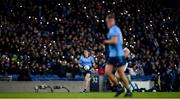 24 February 2024; Lee Gannon of Dublin runs up the field as supporters use the torch on their phones to shine a light for hope during 'Light Up Croke Park for Peace in Palestine' in the 20th minute of the Allianz Football League Division 1 match between Dublin and Kerry at Croke Park in Dublin. Photo by Shauna Clinton/Sportsfile