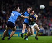 24 February 2024; Keith Evans of Kerry is tackled by Seán Bugler and Brian Fenton of Dublin, 8, during the Allianz Football League Division 1 match between Dublin and Kerry at Croke Park in Dublin. Photo by Shauna Clinton/Sportsfile