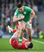 24 February 2024; Dan Sheehan of Ireland evades the tackle of Josh Adams of Wales during the Guinness Six Nations Rugby Championship match between Ireland and Wales at the Aviva Stadium in Dublin. Photo by Seb Daly/Sportsfile