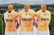 25 February 2024; Antrim supporters, from left, Ciarán, Caoimhín, and Seán Og Donnelly pose for a photograph with an Antrim jersey cut-out before the Allianz Hurling League Division 1 Group B match between Antrim and Galway at Corrigan Park in Belfast. Photo by Tyler Miller/Sportsfile