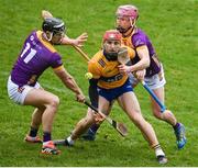 25 February 2024; Darragh Lohan of Clare in action against Wexford players Lee Chin, left, and James Byrne during the Allianz Hurling League Division 1 Group A match between Wexford and Clare at Chadwicks Wexford Park in Wexford. Photo by Seb Daly/Sportsfile