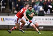 25 February 2024; Declan McCusker of Fermanagh is tackled by Damien Gore of Cork during the Allianz Football League Division 2 match between Fermanagh and Cork at St Joseph’s Park in Ederney, Fermanagh. Photo by Ben McShane/Sportsfile
