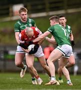 25 February 2024; Brian O'Driscoll of Cork in action against Brandon Horan, left, and Ronan Caffrey of Fermanagh during the Allianz Football League Division 2 match between Fermanagh and Cork at St Joseph’s Park in Ederney, Fermanagh. Photo by Ben McShane/Sportsfile