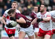 25 February 2024; John Daly of Galway in action against Niall Loughlin of Derry during the Allianz Football League Division 1 match between Galway and Derry at Pearse Stadium in Galway. Photo by Ray Ryan/Sportsfile