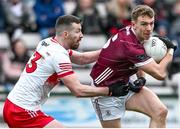 25 February 2024; Dylan McHugh of Galway in action against Niall Loughlin of Derry during the Allianz Football League Division 1 match between Galway and Derry at Pearse Stadium in Galway. Photo by Ray Ryan/Sportsfile