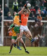 25 February 2024; Andrew Murnin of Armagh catchs a kickout ahead of Hugh McFadden of Donegal during the Allianz Football League Division 2 match between Armagh and Donegal at BOX-IT Athletic Grounds in Armagh. Photo by Brendan Moran/Sportsfile