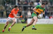 25 February 2024; Caolan McGonagle of Donegal in action against Rory Grugan of Armagh during the Allianz Football League Division 2 match between Armagh and Donegal at BOX-IT Athletic Grounds in Armagh. Photo by Brendan Moran/Sportsfile