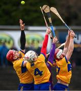 25 February 2024; Clare players, from left, John Conlon, Adam Hogan and Conor Leen contest a high ball with Wexford's Séamus Casey, hidden, during the Allianz Hurling League Division 1 Group A match between Wexford and Clare at Chadwicks Wexford Park in Wexford. Photo by Seb Daly/Sportsfile