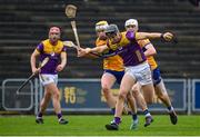 25 February 2024; Jack O'Connor of Wexford in action against Clare players Seán Rynne, left, and Cian Galvin during the Allianz Hurling League Division 1 Group A match between Wexford and Clare at Chadwicks Wexford Park in Wexford. Photo by Seb Daly/Sportsfile