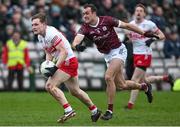 25 February 2024; Ethan Doherty of Derry in action against John Maher of Galway during the Allianz Football League Division 1 match between Galway and Derry at Pearse Stadium in Galway. Photo by Ray Ryan/Sportsfile