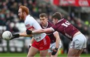 25 February 2024; Conor Glass of Derry in action against Dylan McHugh and Liam O Conghaile of Galway during the Allianz Football League Division 1 match between Galway and Derry at Pearse Stadium in Galway. Photo by Ray Ryan/Sportsfile