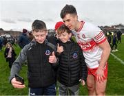 25 February 2024; Shane McGuigan of Derry takes a photograph with supporters after the Allianz Football League Division 1 match between Galway and Derry at Pearse Stadium in Galway. Photo by Ray Ryan/Sportsfile