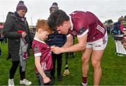 25 February 2024; Sean Kelly of Galway signs the jersey of Galway supporter Donnach Kelly, from Ballygar in Galway, after the Allianz Football League Division 1 match between Galway and Derry at Pearse Stadium in Galway. Photo by Ray Ryan/Sportsfile