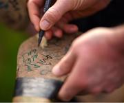 25 February 2024; Eoin Cody of Kilkenny signs his autograph on a hurl after the Allianz Hurling League Division 1 Group A match between Kilkenny and Offaly at UPMC Nowlan Park in Kilkenny. Photo by Tom Beary/Sportsfile