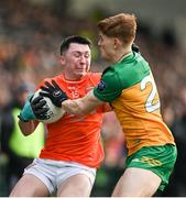 25 February 2024; Oisín Conaty of Armagh in action against Ciarán Moore of Donegal during the Allianz Football League Division 2 match between Armagh and Donegal at BOX-IT Athletic Grounds in Armagh. Photo by Brendan Moran/Sportsfile