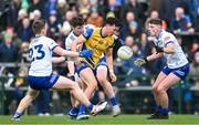 25 February 2024; Tadhg O'Rourke of Roscommon in action against Monaghan players, from left, Mícheál Bannigan, Darren Hughes, and Thomas McPhilips during the Allianz Football League Division 1 match between Roscommon and Monaghan at Dr Hyde Park in Roscommon. Photo by Daire Brennan/Sportsfile