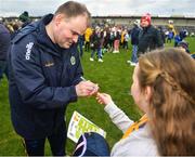 25 February 2024; Roscommon manager Davy Burke signs a Kit Kat bar of Roscommon supporter Saoirse Egan, aged 10, from Ballintubber in Roscommon, after the Allianz Football League Division 1 match between Roscommon and Monaghan at Dr Hyde Park in Roscommon. Photo by Daire Brennan/Sportsfile