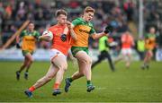 25 February 2024; Rian O'Neill of Armagh is tackled by Ciarán Moore of Donegal during the Allianz Football League Division 2 match between Armagh and Donegal at BOX-IT Athletic Grounds in Armagh. Photo by Brendan Moran/Sportsfile